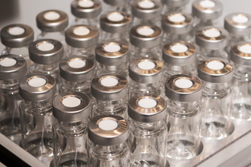 Glass vials for liquid samples. Laboratory equipment for dispensing fluid samples.