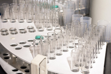 Fototapeta na wymiar Glass vials for liquid samples. Laboratory equipment for dispensing fluid samples.