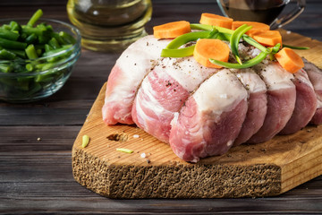 Raw pork chop marinated meat roll with assorted vegetables