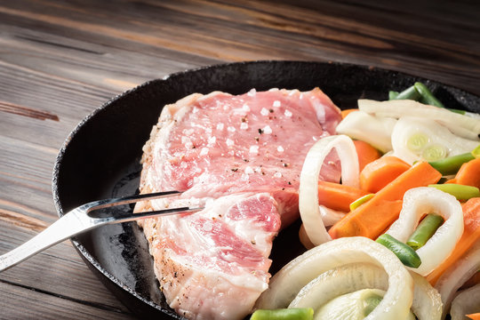 Raw pork chop marinated meat roll with assorted vegetables