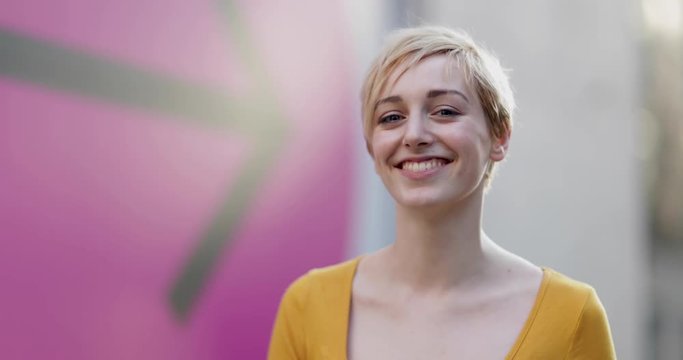 Portrait of young adult female with arrow sign in background