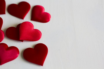 Hearts on white wooden background