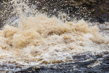 Stormy mountain river with large waves