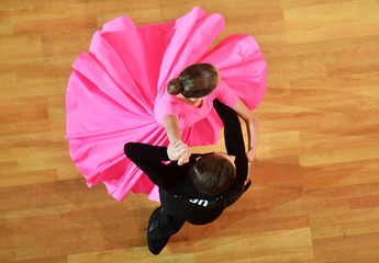 Dancers performing in a competition of ballroom dancing