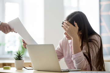 Frustrated female employee feeling upset receiving dismissal notice from boss getting fired losing job, depressed bankrupt businesswoman distraught by paper notification about debt, student expelled - obrazy, fototapety, plakaty
