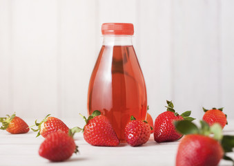 Plastic bottle of berries soda juice drink on wood