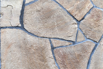 Brown stone wall, background, texture, rectangular natural stones of different shades