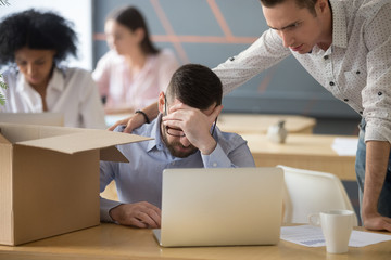 Colleague supporting dismissed depressed male employee got fired on last working day, upset...