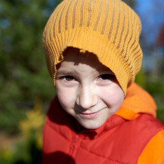Outdoor portrait of cute Caucasian boy.