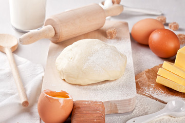 Dough preparation recipe for bread, pizza, pasta, cookies or pie ingridients, food flat lay on kitchen table background. Working with butter, milk, yeast, flour, eggs, sugar pastry or bakery cooking.