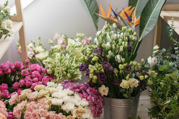 Flower shop concept. Different varieties fresh spring flowers in refrigerator room for flowers. Bouquets on shelf, florist business.