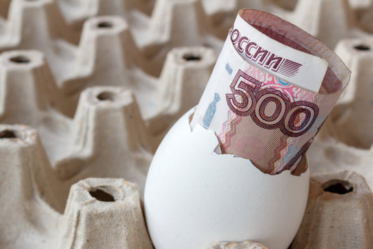 Russian ruble banknote in egg shell in empy cardboard tray
