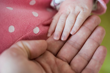 Newborn baby, closeup of fingers of fingers on hand of mother