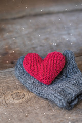 Knitted red heart on the handmade mitt, Valentine's Day postcard