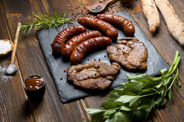 Delicious grilled meat on a dark background.