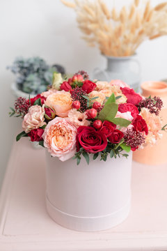 Multicolor bouquet of beautiful flowers on wooden table. Floristry concept. Spring colors. the work of the florist at a flower shop. Vertical photo