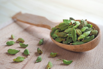 Spice cardamom in a wooden spoon.