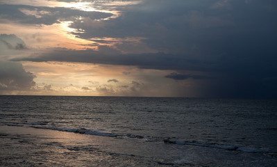 Bali, Indonesia. Sunset over the sea coast reflected in the water