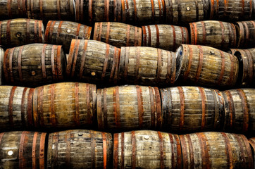 Stacked pile of old whisky and wine wooden barrels - 203602719