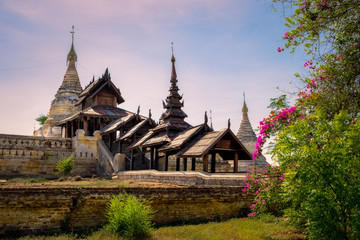 Fototapeta na wymiar Beautiful view of ancient temple in old Bagan with flowers foreground