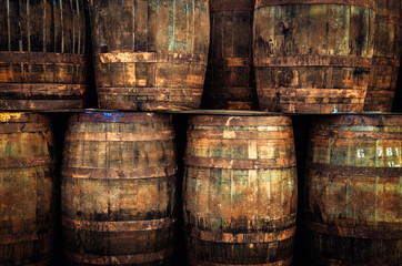 Detail of stacked old wooden whisky barrels - 203602996