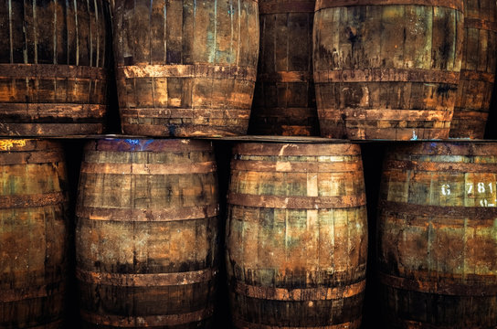 Detail of stacked old wooden whisky barrels