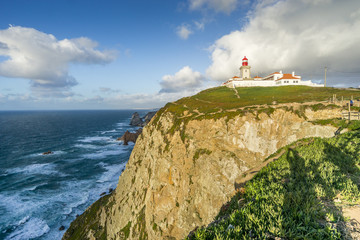 Fototapeta na wymiar Lighthouse on the cliffs on Cape Roca, Sintra - Cascais Natural Park, Portugal