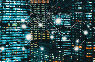 Network and connection technology conceptwith skyscrapers illuminated at night in Tokyo, Japan