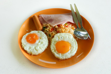 Traditional full English breakfast with fried eggs, sausages and bacon on wooden background 