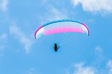 Paraglider flying in a cloudy day.