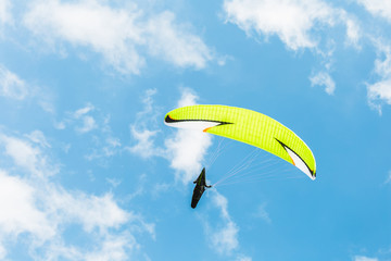 Paraglider flying in a cloudy day.