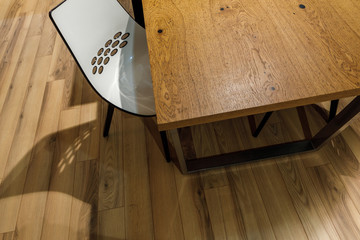 Fototapeta na wymiar Modern white chair by wooden table