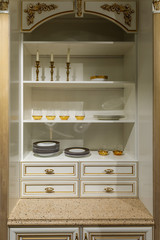 Interior of modern kitchen with elegant tableware in cupboard