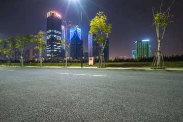 Empty asphalt road through modern city