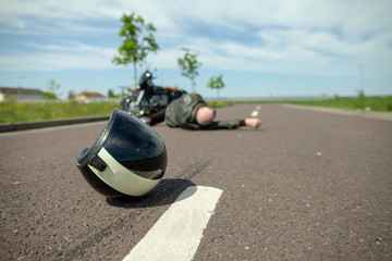 Naklejka premium kask motocyklowy leży na ulicy w pobliżu wypadku motocyklowego