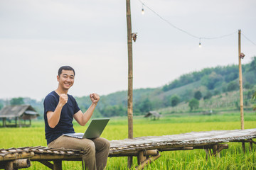 Fototapeta premium Asian young businessman working on his laptop. Digital Economy.