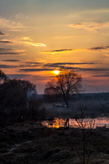 Fototapeta premium Heaps of people rest on nature during the sunset in April