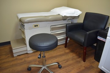 Doctor examining room with a leather chair and stool