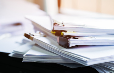 Stack of papers documents in archives files with clip papers on table at offices,  Busy offices and...