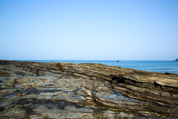 Fototapeta na wymiar Multistory layered rough and sedimentary rocks in famous tourist site Chaeseokgang Coast in Buan-gun, South Korea.