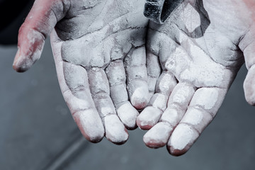 Close up of hands with chalk ready for exercising.