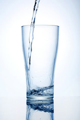 Glass cup with water on a white background.