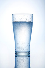 Glass cup with water on a white background.