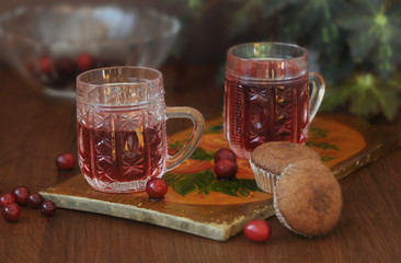 Two glass mugs with fresh berry juice in and two homemade chocolate muffins. Close-up © elena_p