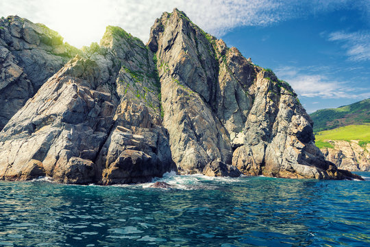 Rocky coast of Japanese sea in Russia, image taken from a boat