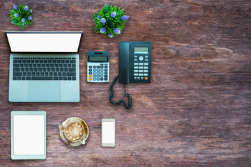 Top view desk work office with Laptop on wooden background.