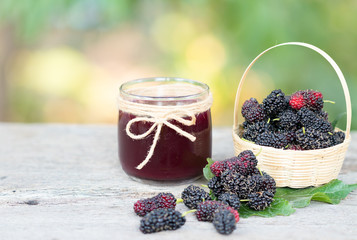 Mulberry juice and fresh mulberry on wooden table