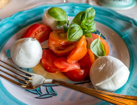 Buffalo mozzarella with fresh tomatoes and basilic at Positano  restaurant. Selective focus.
