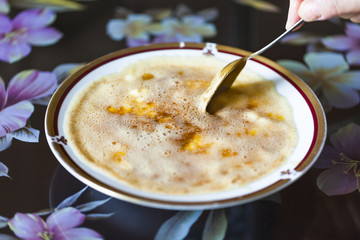Georgian national dish in a plate on the table. Adjara cheese in butter Borano