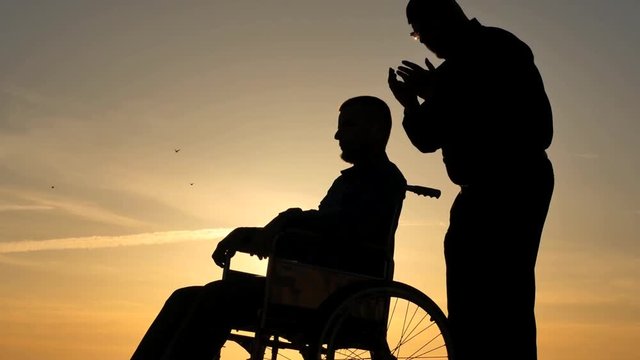 Man making healing hypnosis session for patient silhouette